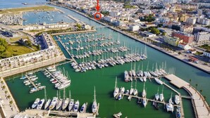 A marina with numerous boats docked, surrounded by urban buildings and a clear sky. - (^ ‿ ^) Cozy & Bright, near the Beach, Marina, Historic Center and Supermarket (Lagos)