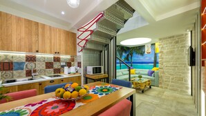 A modern kitchen with a wooden cabinet, a colorful backsplash, and a dining area with a table set for two. - Petra design apartment Dubrovnik; FREE wireless internet and breakfast! (Dubrovnik)