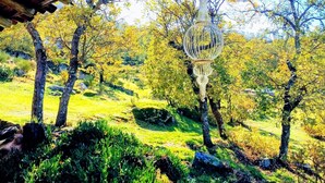 A rustic wooden structure with a hanging lantern. - Country House with Swimming Pool Large Terrace and an amazing panoramic view (Marvão)