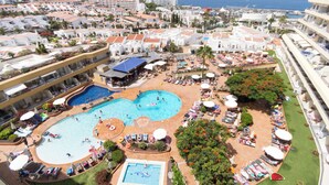 A resort with multiple swimming pools, sun loungers, and a view of the ocean. - Santa Maria 99 - One Bed (Costa Adeje)