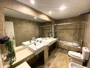 Tina con regadera, secadora de cabello, bidet, toallas
