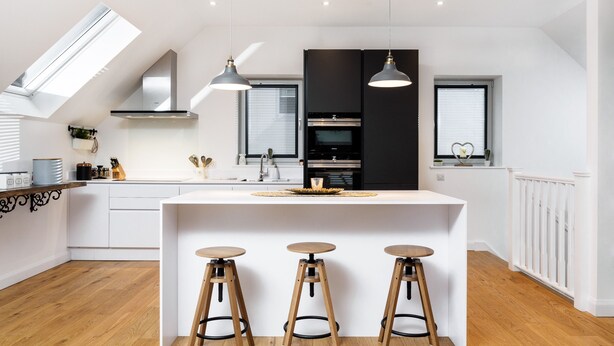 A modern kitchen with a central island, three stools, and a skylight. - Taymore Lodge, your home away from home... (Kenmore)