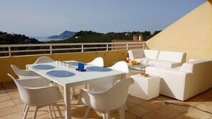 A terrace with a white table and chairs, a sofa, and a view of the sea and hills. - Near sea and quiet, beautiful view   (Altea)