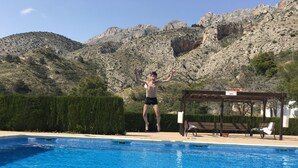 A swimming pool with clear blue water, surrounded by a wooden pergola and lounge chairs. - Near sea and quiet, beautiful view   (Altea)
