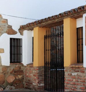 Traditional building with a distinctive architectural style, featuring a brick base and terracotta roof.