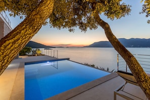 Seasonal outdoor pool, an infinity pool, pool loungers