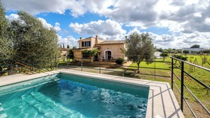 A swimming pool with a view of a house and a grassy area. - Nice relaxing country house with private pool (Inca)