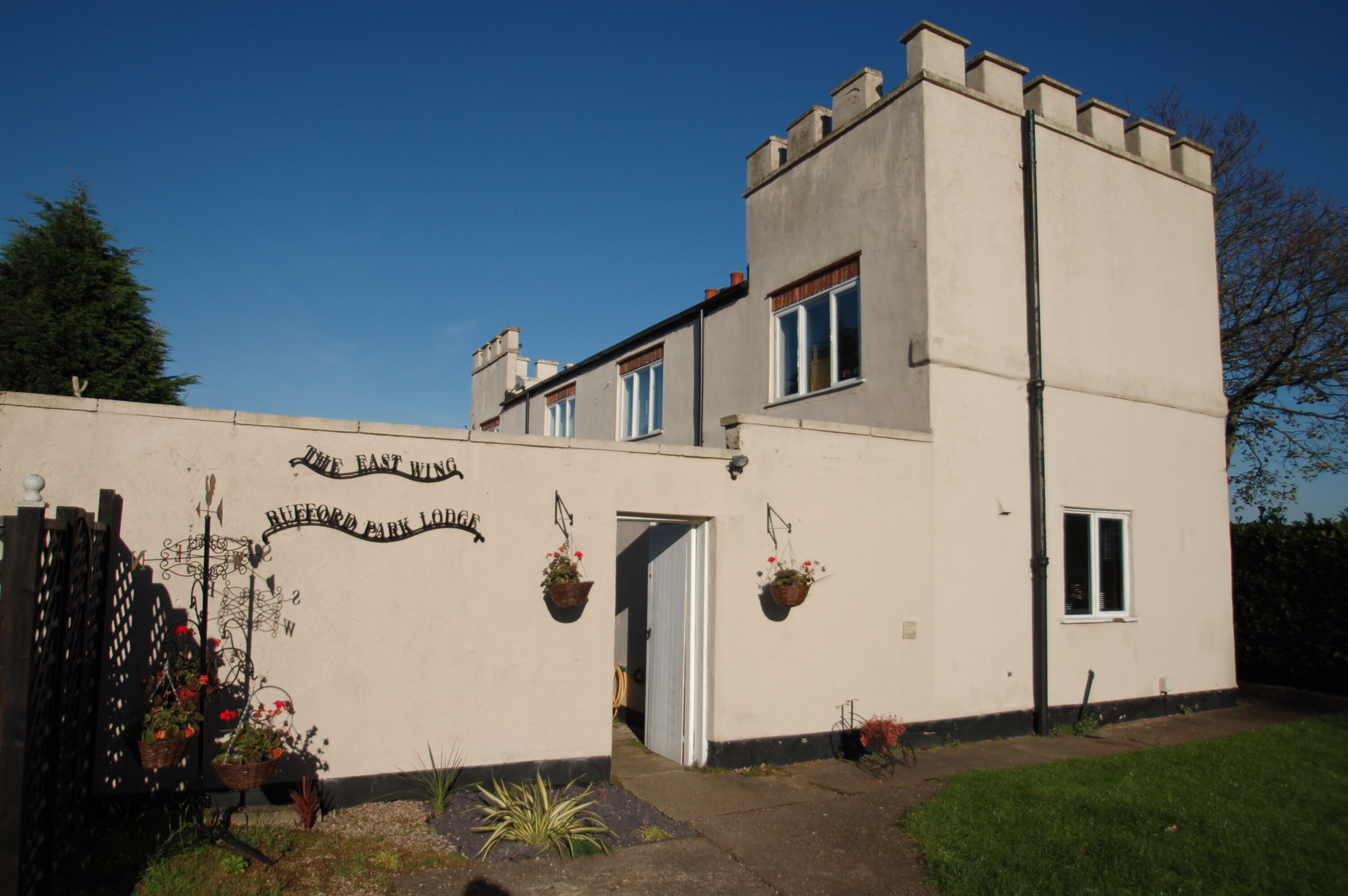 A building with a sign reading "The East Wing" and "BUFFORD PARK LODGE".