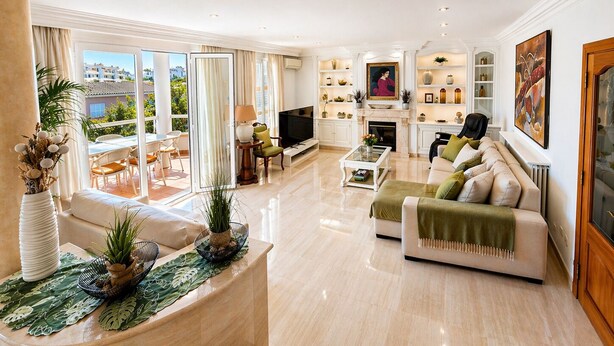 A spacious living room with a fireplace, a television, and a balcony with a view. - Villa in the City Center (Palma)