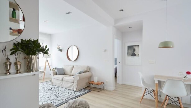 A modern living room with a sofa, coffee table, and dining area. - Nice and cozy apartment in Pamplona center! (Pamplona/Iruña)