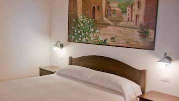 Cozy retreat with a single bed, bedside tables, and a beautiful framed painting.