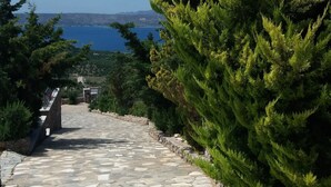 A stone pathway leading to a scenic overlook with a view of the sea and distant hills. - Bay View Villa I in Crete with private swimming pool and modern convenient (Chania)