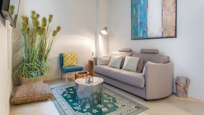 A living room with a sofa, a coffee table, a lamp, and a painting on the wall. - Sa Caseta. (Sóller)