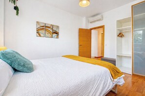 A bedroom with a bed, a wardrobe, a hanging plant, and a painting on the wall. - Magnificent Villa with large pool and garden with 100% private views in Seville (Guillena)