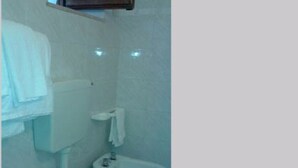 Un bagno piccolo con il water, un bidet e un lavandino.