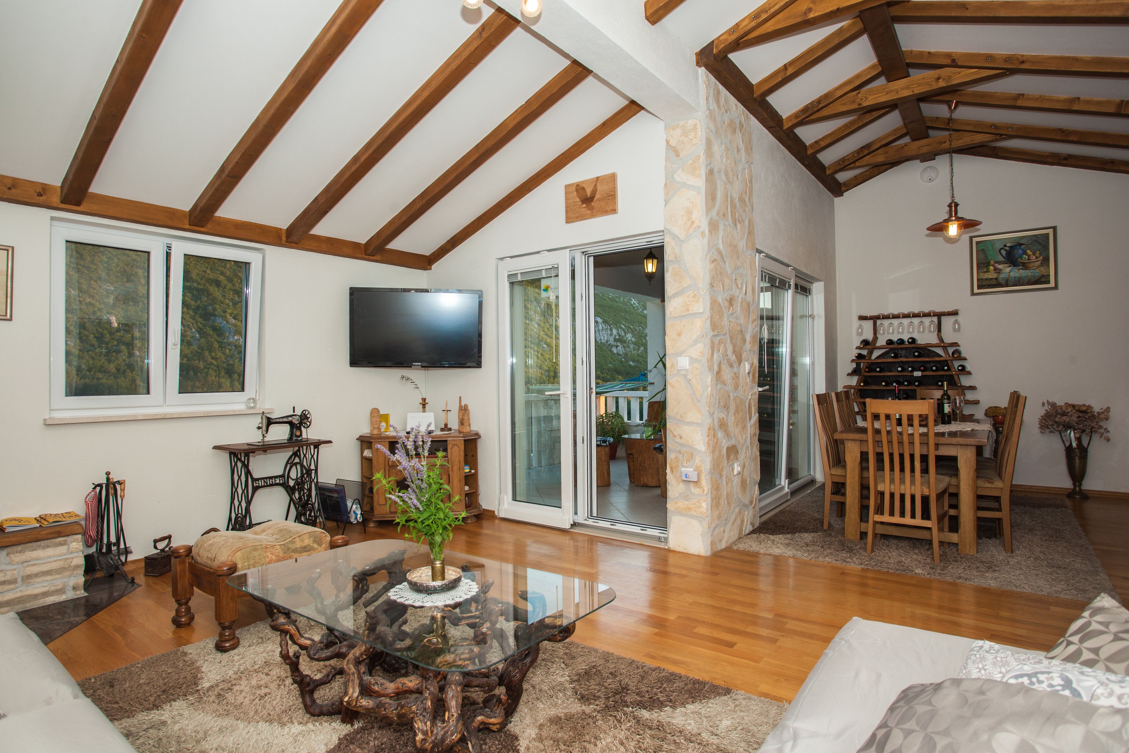 Living room, view of the sitting area, television, balcony and dinning room.