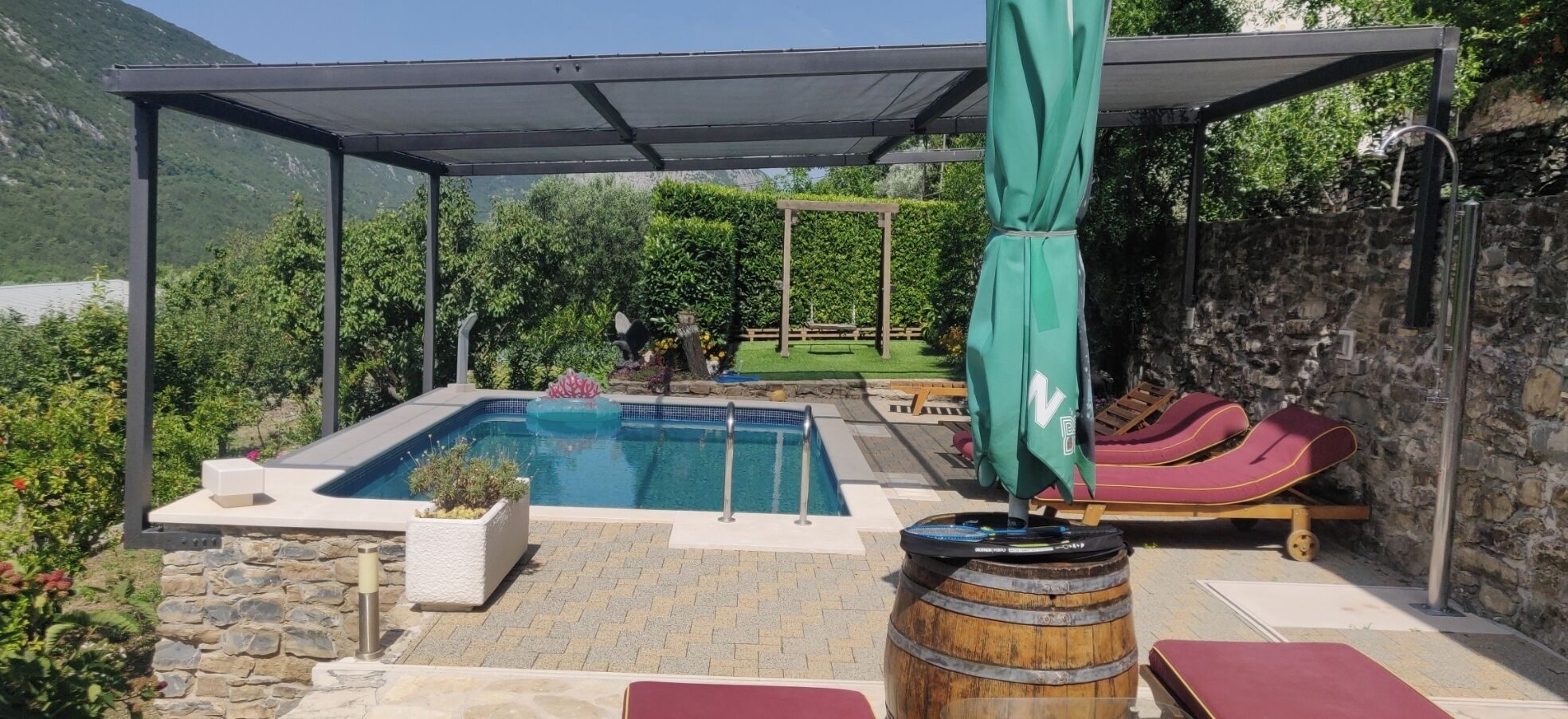 View on a newly built shade structure above the swimming pool and sun loungers
