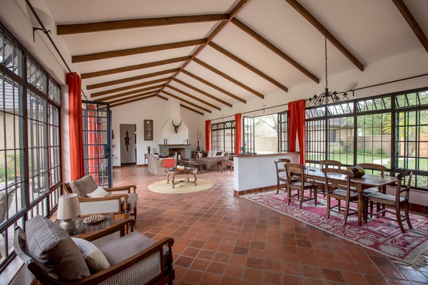 Open plan living/dining area with fire place and access to courtyard and fairway