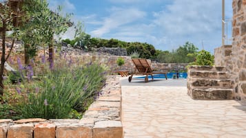 Escape to a serene oasis surrounded by lush greenery and tranquil water features.