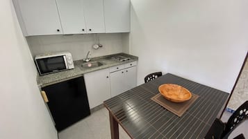 Fridge, microwave, coffee/tea maker, cookware/dishes/utensils