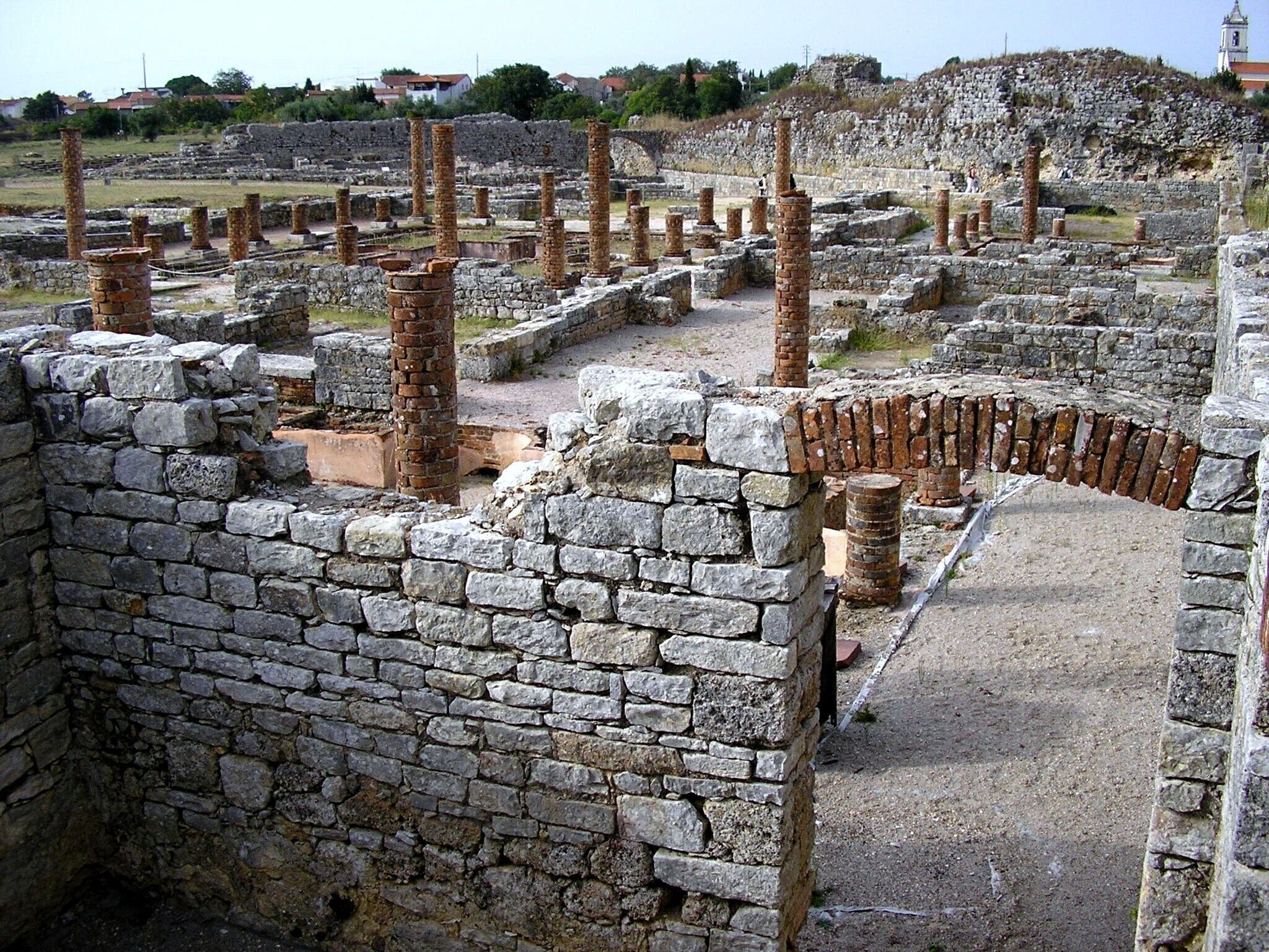 Ancient ruins with stone walls and columns.