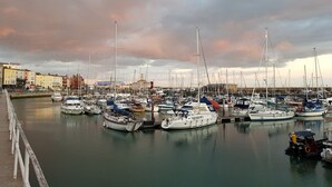 A marina with numerous boats docked, a waterfront promenade, and buildings in the background. - Luxury studio suite at Hawthorn Farm, kingsize bed, jacuzzi bath, private garden (Canterbury)