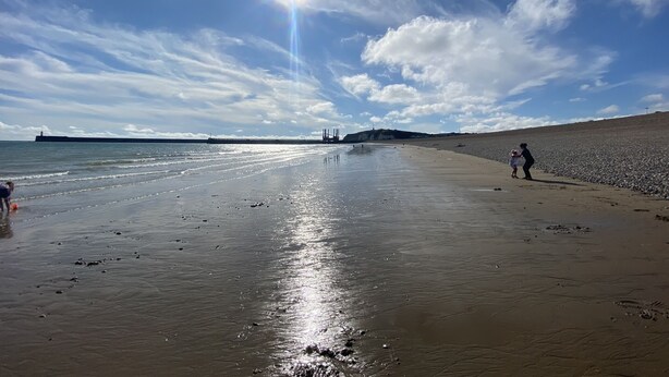 A beach with a long stretch of sand, a body of water, and a distant bridge. - Rural Retreat in deepest Sussex (Lewes)