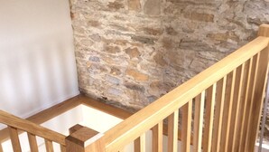 A wooden staircase with a stone wall background. - Romantic Rural Retreat, Ideal Base to Explore Cornwall (Wadebridge)