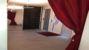 A hallway with a sliding glass door, a red curtain, a ceiling fan, and a tiled floor. - superb house ideally located 220 m2 (Sainte-Sève)