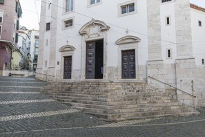 A building with a stone staircase leading to a set of doors.