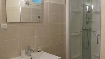 Bathtub, hair dryer, soap, toilet paper