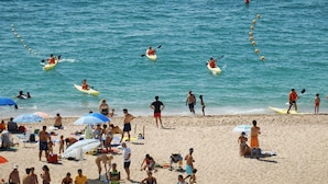 A beach with kayakers, people sunbathing, and beach umbrellas. - Spectacular Frontline, Pineda de Mar (Pineda de Mar)