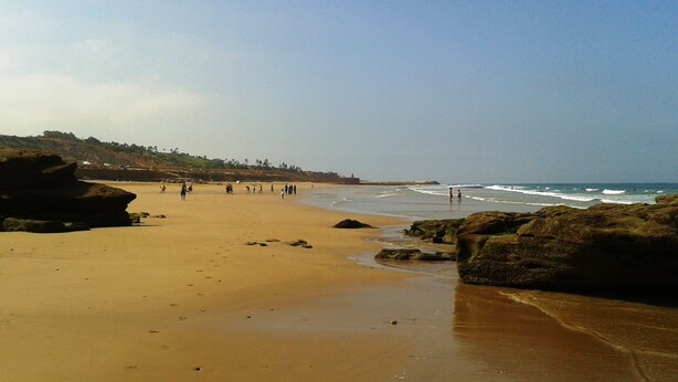 A sandy beach with rocky outcrops and a clear sky. - Aourir: House / Villa - Aourir (Aourir)
