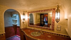 A bathroom with a large mirror, a sink with a decorative tile backsplash, and a shower area. - Room 1 - 18th century riad in the center of essaouira medina (Marrakech-Safi)