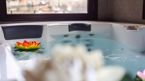 A hot tub with a lotus flower and a white flower in the water.