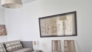 A hotel room with a bed, a desk, a chair, a lamp, and a framed artwork on the wall. - In Florence, sunny and beautiful two-story flat, well connected to the center (Firenze)