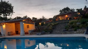 A poolside area with a clear view of a swimming pool, a covered seating area, and a stone staircase leading to a building. - LARGE HOUSE, GORDES , heated swimming pool , view over Goult, Roussillon (Joucas)
