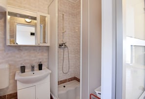Shower, hair dryer, towels, toilet paper