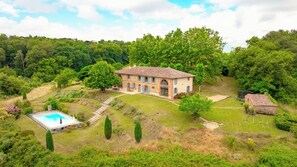 A large house with a swimming pool, surrounded by lush greenery and trees. - House with character (Lézat-Sur-Lèze)