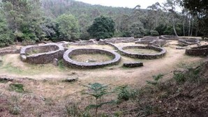 Ancient terraced stone structures in a forested area.