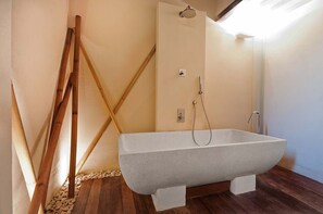 Een bad/douchecombinatie, een haardroger, een bidet, handdoeken