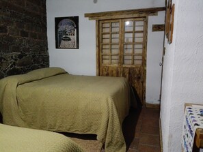 Cozy retreat with a rustic charm, featuring a comfortable bed and traditional decor.