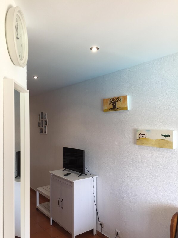 A room with a white cabinet, a flat-screen TV, and artwork on the wall. - Located in the heart of Albufeira, 1.5 km from Oura Beach, 2.5 km (Albufeira)