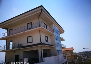 Stunning multi-story building with a flat roof and expansive windows.