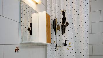 Bathtub, hair dryer, soap, toilet paper