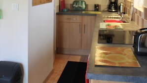 A compact kitchen with wooden beams, a microwave, a coffee maker, and a toaster. - Les Pins at La Cerniére with shared pool (Deneze sous Le Lude)