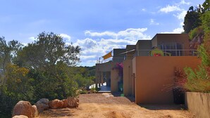 A modern building with a gravel pathway leading to a covered entrance.