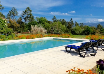 Large fresh water swimming pool with mountain views . In a raised bank for heat