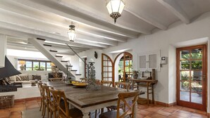 A spacious dining area with a wooden table, chairs, and a staircase leading to another level. - Beautiful Country Villa With Private Pool & Huge Garden (Sóller)