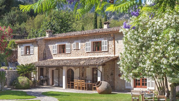 A stone building with a tiled roof, outdoor seating, and a large planter. - Beautiful Country Villa With Private Pool & Huge Garden (Sóller)